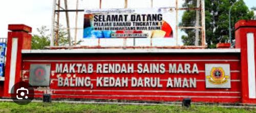 a red building with writing on the side of it at Jerai Geopark Cottage Alamanda in Baling