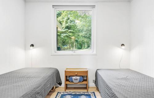 a bedroom with two beds and a window at Gorgeous Home In Rødekro With Wifi in Rødekro