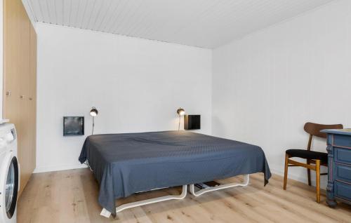 a bedroom with a bed and a table and a chair at Gorgeous Home In Rødekro With Wifi in Rødekro