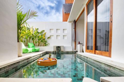 a swimming pool in the middle of a house at Dive into Bliss - Brand New Seminyak Villa with Private Pool in Seminyak