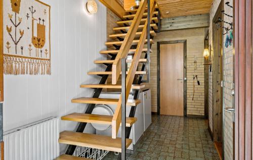 a wooden spiral staircase in a room with a hallway at Stunning Home In Højslev With Wifi in Højslev