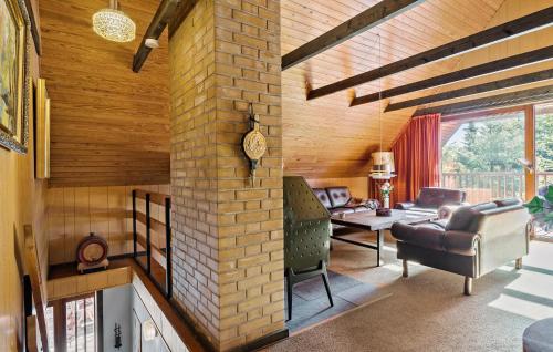 a living room with a brick fireplace in a house at Stunning Home In Højslev With Wifi in Højslev