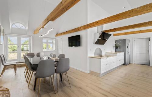 a kitchen and dining room with a table and chairs at Nice Home In Janderup Vestj With Sauna in Billum
