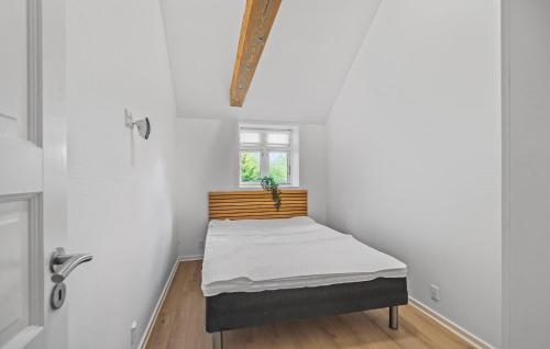 a bed in a room with a window at Nice Home In Janderup Vestj With Sauna in Billum