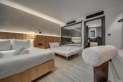 a hotel room with a bed and a chair at Noru Hotel Malta - Adults Only Hotel in St Julian's
