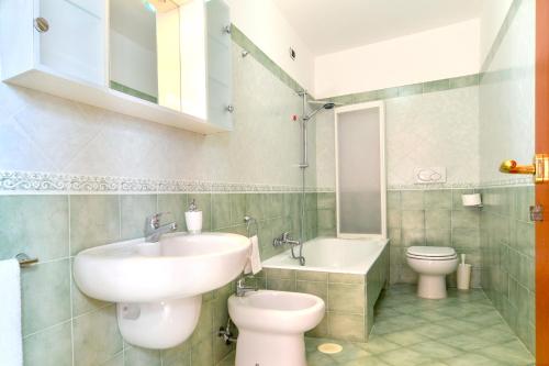 a bathroom with a sink and a toilet at Green Paradise Affittacamere in SantʼAgata sui Due Golfi