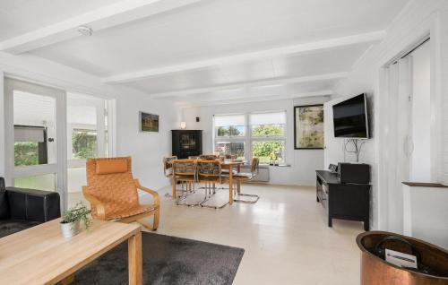 a living room with a table and a dining room at Stunning Home In Martofte With Wifi in Martofte