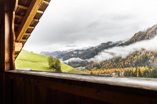 a view from a window of a mountain valley at Hotel Pension Odles in San Martino in Badia