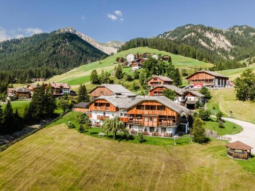 an aerial view of a large house on a hill at Hotel Pension Odles in San Martino in Badia