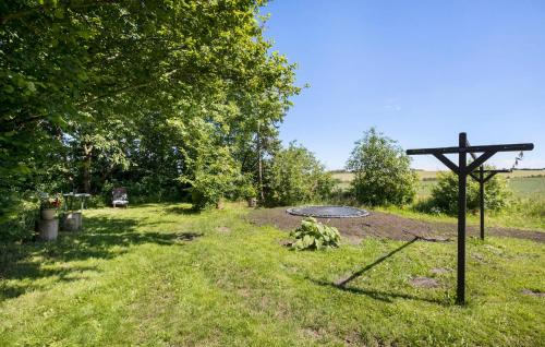 a cross in the grass next to a man hole at Stunning Home In Ranum With Wifi in Ranum