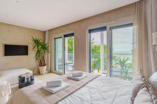 a bedroom with a large bed with a view of the ocean at Boho z Widokiem na Morze by Perłowa Przystań Rent in Sianozety