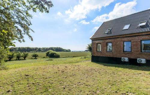 an image of a brick house in a field at Cozy Home In Gudhjem With Wifi in Gudhjem