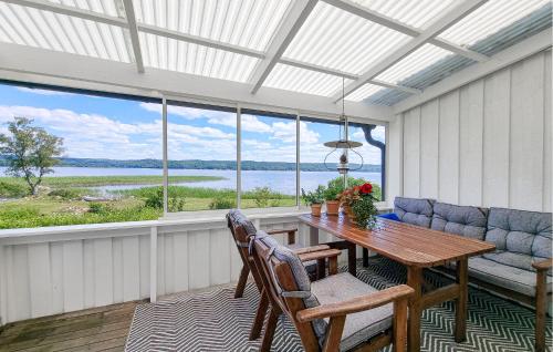 a screened in porch with a table and a couch at 3 Bedroom Stunning Home In Tvärred in Ulricehamn