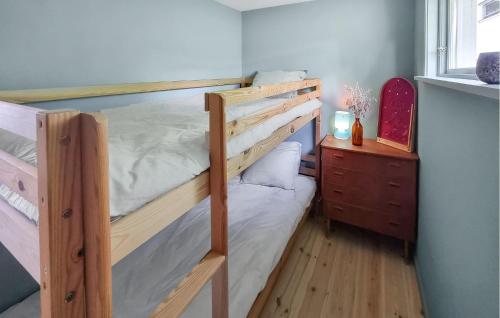 a bedroom with two bunk beds and a dresser at 3 Bedroom Stunning Home In Tvärred in Ulricehamn