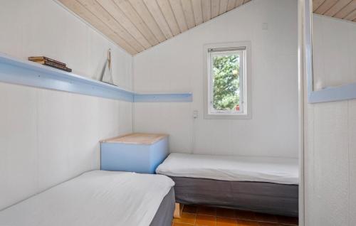 two beds in a small room with a window at Stunning Home In Middelfart With Wifi in Middelfart