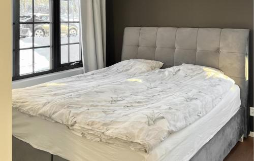 an unmade bed in a bedroom next to a window at Gorgeous Apartment In Idre With Sauna in Idre