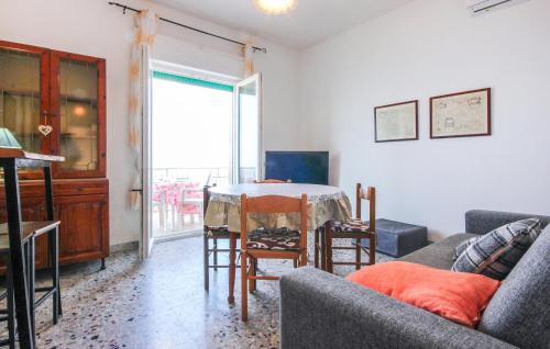 a living room with a couch and a table with chairs at Beautiful Apartment In Castellabate in Castellabate