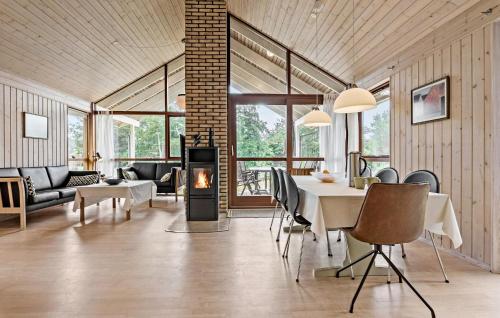 a living room with a table and a fireplace at 3 Bedroom Beautiful Home In Løgstør in Løgstør