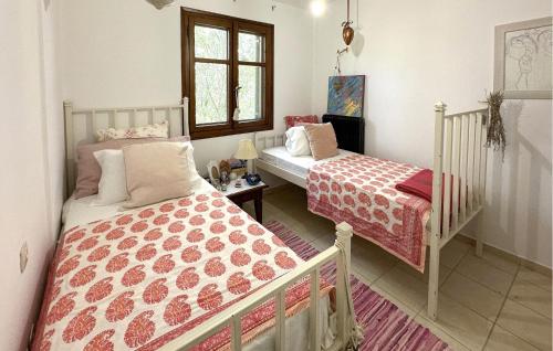 a bedroom with two beds and a window at Pet Friendly Home In Astros Arkadia in Astros