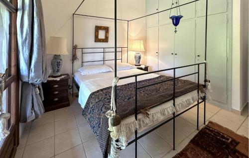 a bedroom with a bed with a metal frame at Pet Friendly Home In Astros Arkadia in Astros