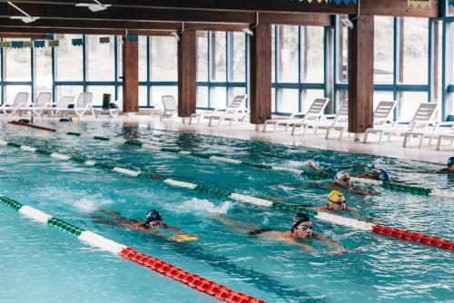 a group of people swimming in a swimming pool at Aparthotel Maso Corto in Maso Corto