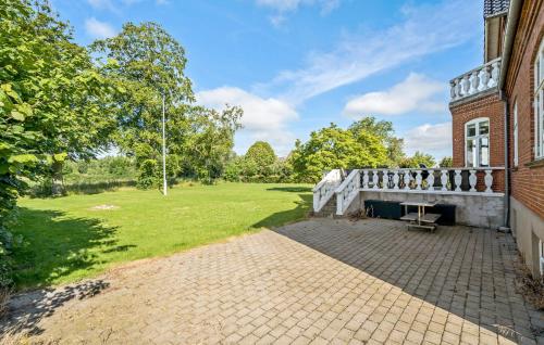 an exterior view of a brick building with a balcony at 5 Bedroom Nice Home In Nyborg in Nyborg