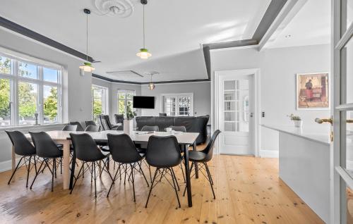 a dining room with a table and chairs at 5 Bedroom Nice Home In Nyborg in Nyborg