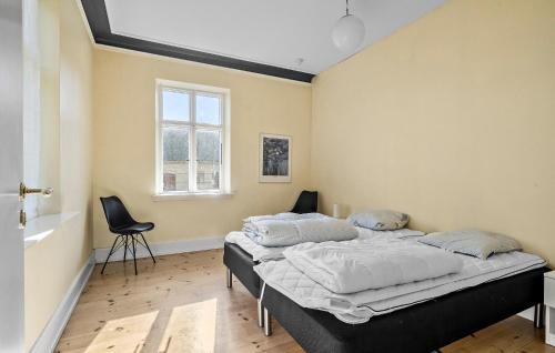 a bedroom with a bed and a window at 5 Bedroom Nice Home In Nyborg in Nyborg