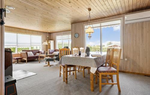a dining room and living room with a table and chairs at 3 Bedroom Lovely Home In Bogense in Bogense