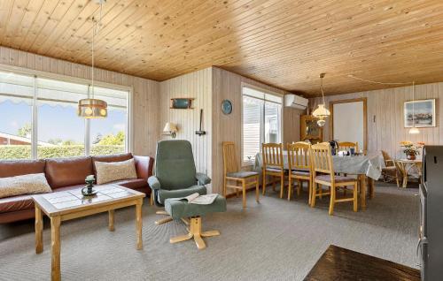 a living room with a couch and a dining room at 3 Bedroom Lovely Home In Bogense in Bogense