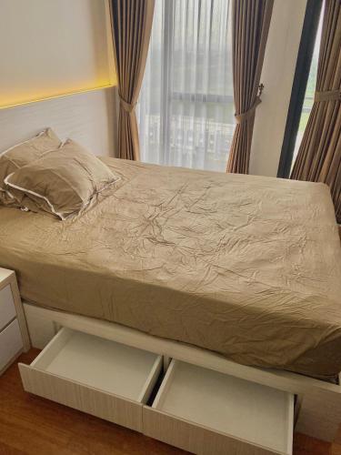 a bed in a room with an open drawer at Monroe Tower Apartment By Kyra Property in Pegadungan
