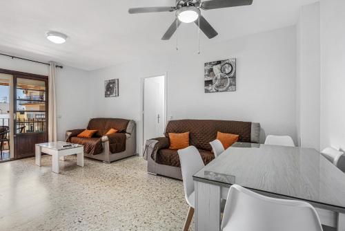 a living room with a couch and a table at Chipiona Centro y Playa in Chipiona
