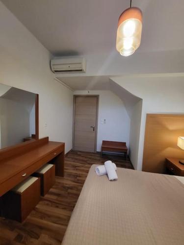 a room with a bed with a mirror and a dresser at Villa Coppa in (( Kermetés ))