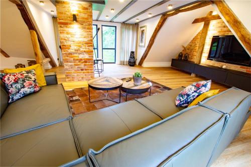 a living room with a couch and a table at Michels Mühle - Pitt sin Atelier in Brilon