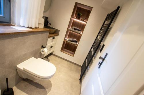 a small bathroom with a toilet and a window at Michels Mühle - Pitt sin Atelier in Brilon