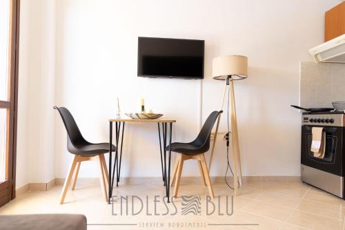 a living room with a table and two chairs at Endless Blu Apartments in Pyrgadikia