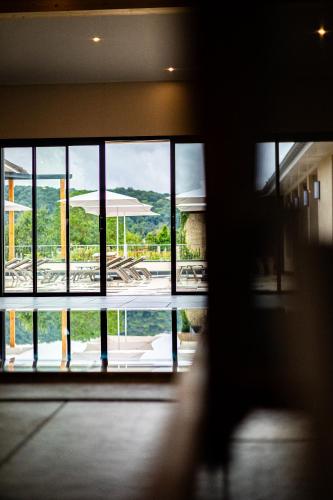 a view of a building from a window in a building at Hôtel SPA du Lac de Madine - Maison DRAPIER in Heudicourt-sous-les-Côtes