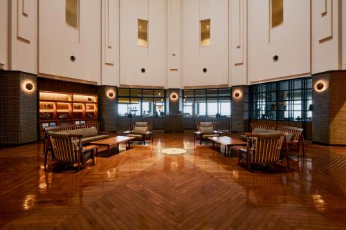 a lobby with tables and chairs in a building at samana hotel Yakushima in Yakushima