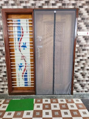a door with a painting on the side of a building at VPR Guest House in Yelagiri