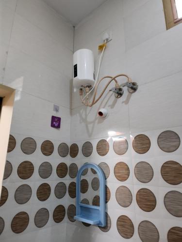 a bathroom with brown circles on the wall at VPR Guest House in Yelagiri