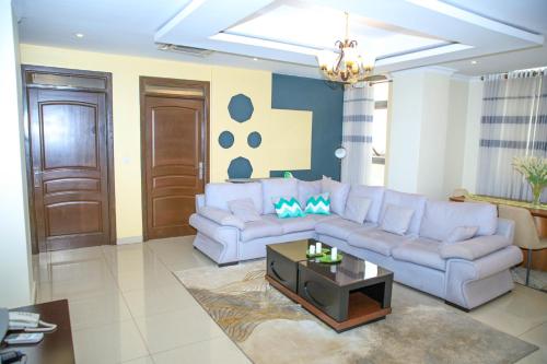 a living room with a couch and a table at IZA Serene city centre apartments in Kigali