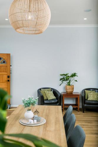 a dining room with a table and chairs at Eden St Lukes Cozy Accommodation in Auckland