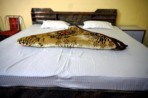 a bed with a pillow on top of it at RAHUL Homestay in Sainj