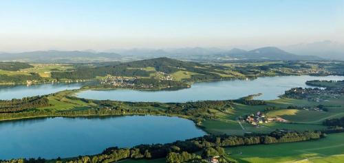 an aerial view of a golf course with two lakes at AP-RANCH Ferienzimmer Sternenblick in Lochen