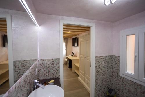 a bathroom with a sink and a toilet in a room at Dal Doge - Guest House in Chioggia