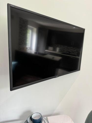 a mirror hanging on a wall with a stove at 2 Bed Apartment Scarisbrick Street Ormskirk - Rooms by Vici in Ormskirk