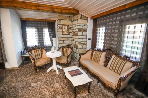 a living room with two chairs and a table at Old House Glavatarski Han in Glavatartsi