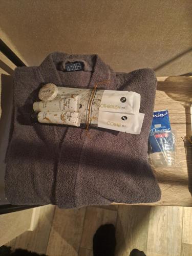 a sweater with a book on top of a table at Lecarréblanc in Izaut-de-lʼHôtel