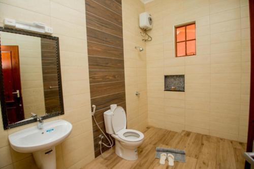 a bathroom with a toilet and a sink at Lindrin lodge moshi in Shiri