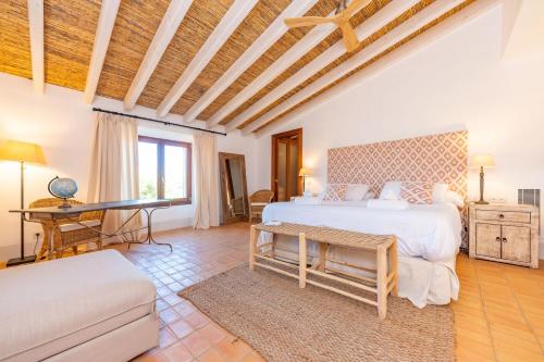 a bedroom with a bed and a desk in a room at Son Catxo in Búger